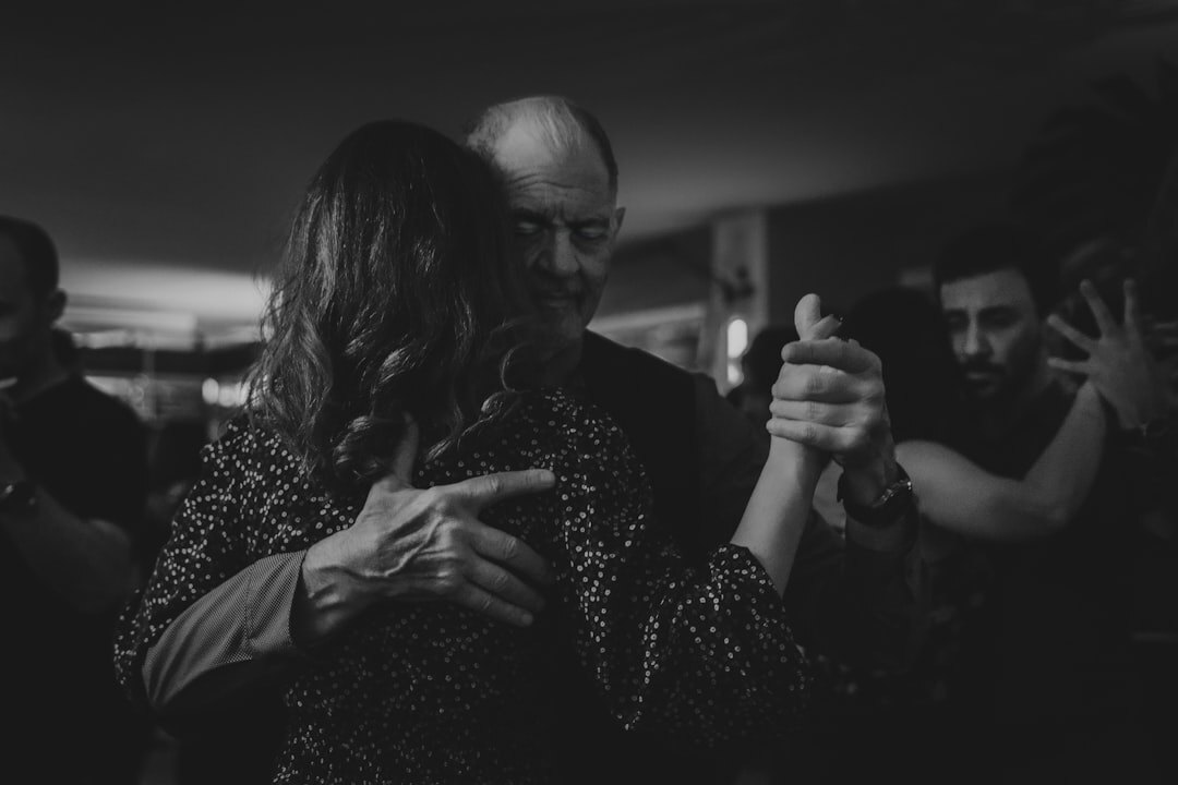 Elderly couple dancing gracefully at a social event
