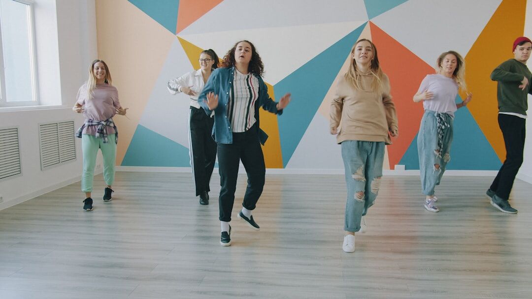 Group of active seniors dancing together indoors